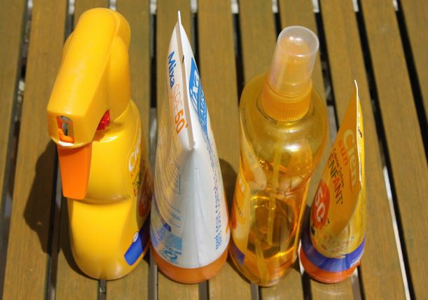 four natural sunscreens on a bench