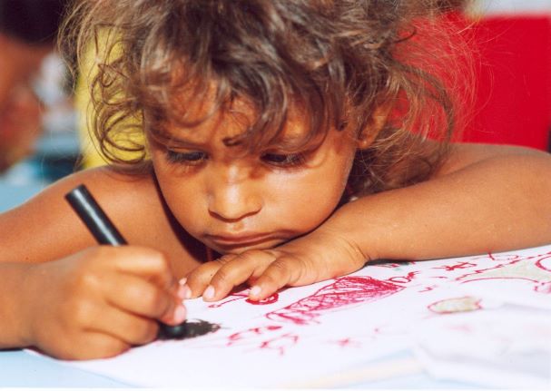 child drawing with crayon